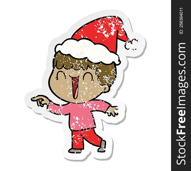 laughing hand drawn distressed sticker cartoon of a man pointing wearing santa hat