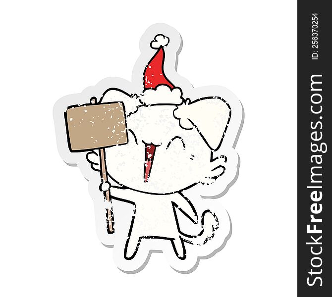 happy little hand drawn distressed sticker cartoon of a dog holding sign wearing santa hat