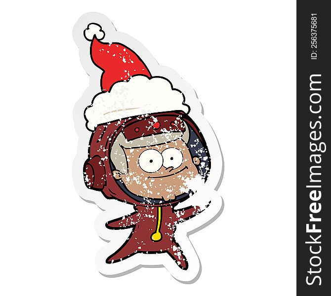happy astronaut hand drawn distressed sticker cartoon of a wearing santa hat