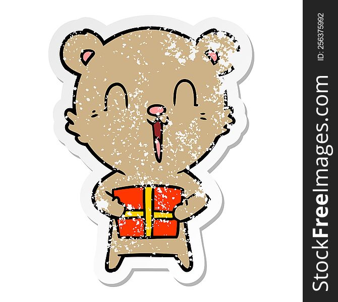 distressed sticker of a happy cartoon bear with christmas gift