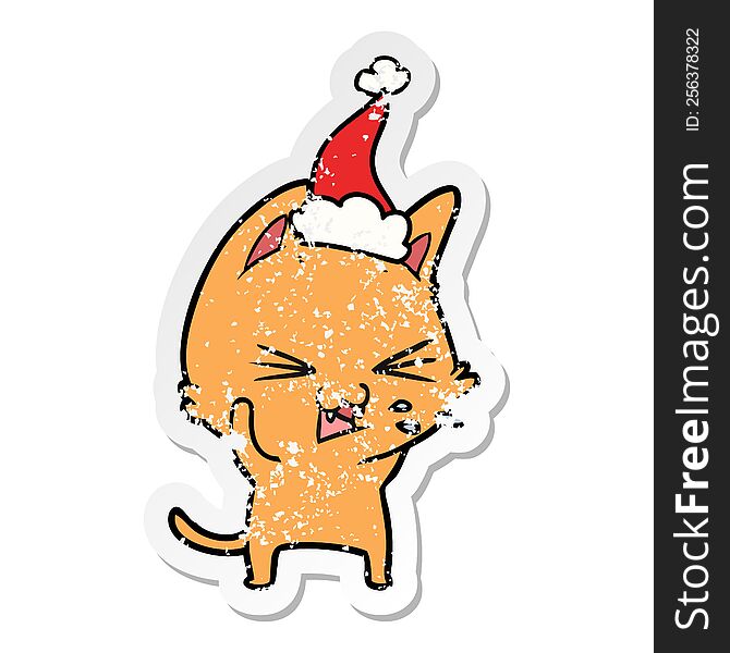 Distressed Sticker Cartoon Of A Cat Hissing Wearing Santa Hat