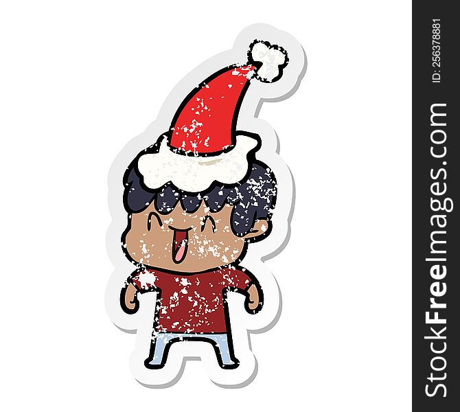 hand drawn distressed sticker cartoon of a laughing boy wearing santa hat