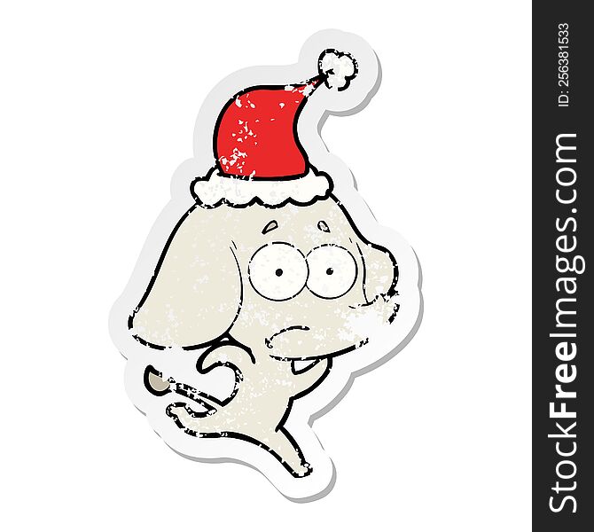 hand drawn distressed sticker cartoon of a unsure elephant running away wearing santa hat