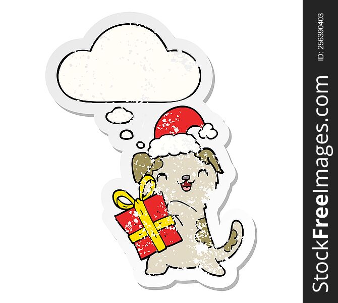 cute cartoon puppy with christmas present and hat with thought bubble as a distressed worn sticker