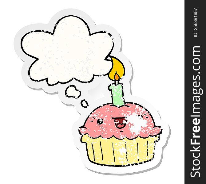 cartoon cupcake with candle with thought bubble as a distressed worn sticker
