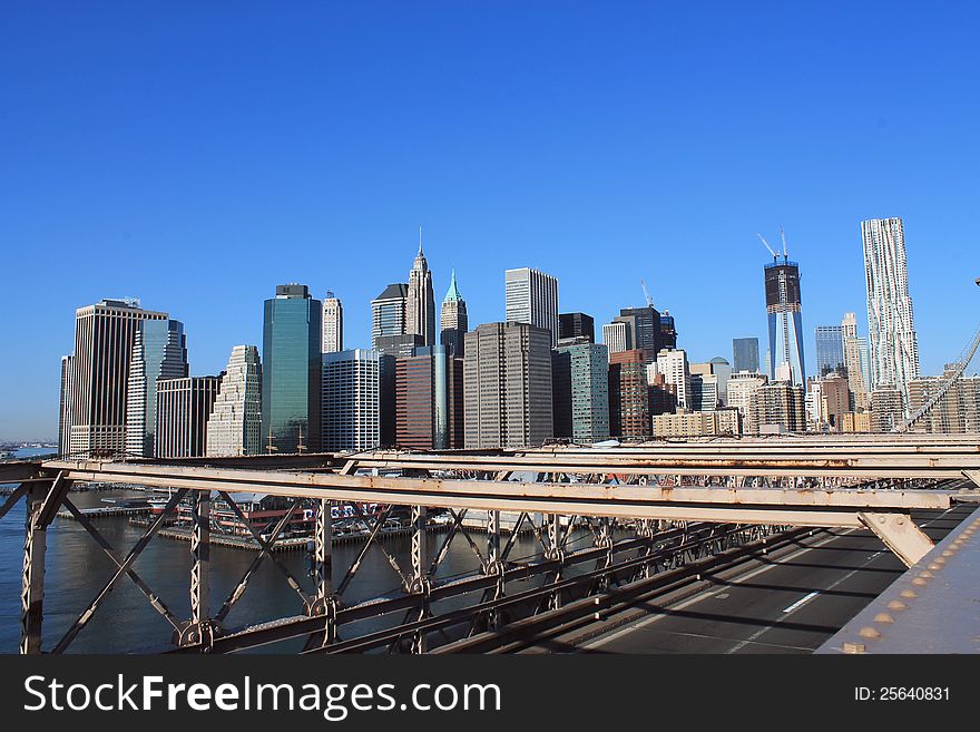 Manhattan in the background of Brooklyn Bridge in a sunny morning, New York, United States