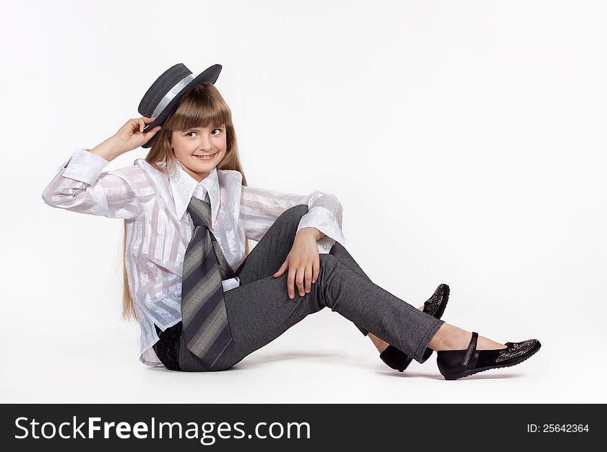 Seated girl in retro hat on a white background