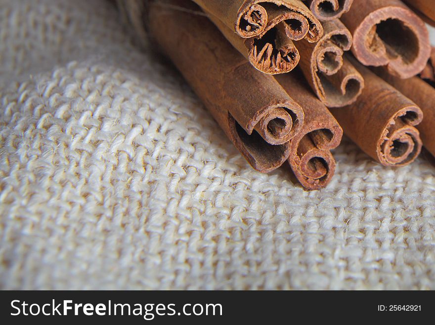 Closeup of cinnamon bark sticks on cotton rug