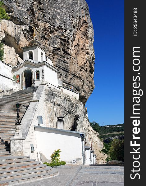 Nice white ortodox temple with long staircase on high mountain. Svyato-Uspensky Monastery in Crimea. Nice white ortodox temple with long staircase on high mountain. Svyato-Uspensky Monastery in Crimea