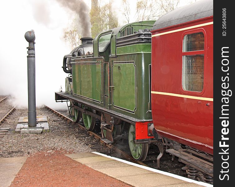 A Vintage Steam Train Pulling Away From The Station. A Vintage Steam Train Pulling Away From The Station.