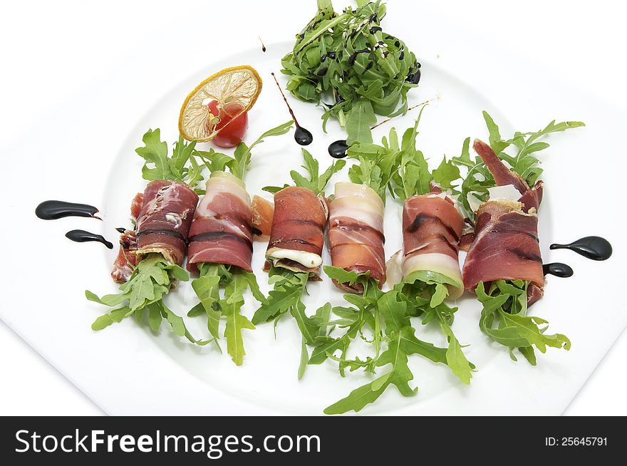 Rolls of meat and greens on a white background in the restaurant