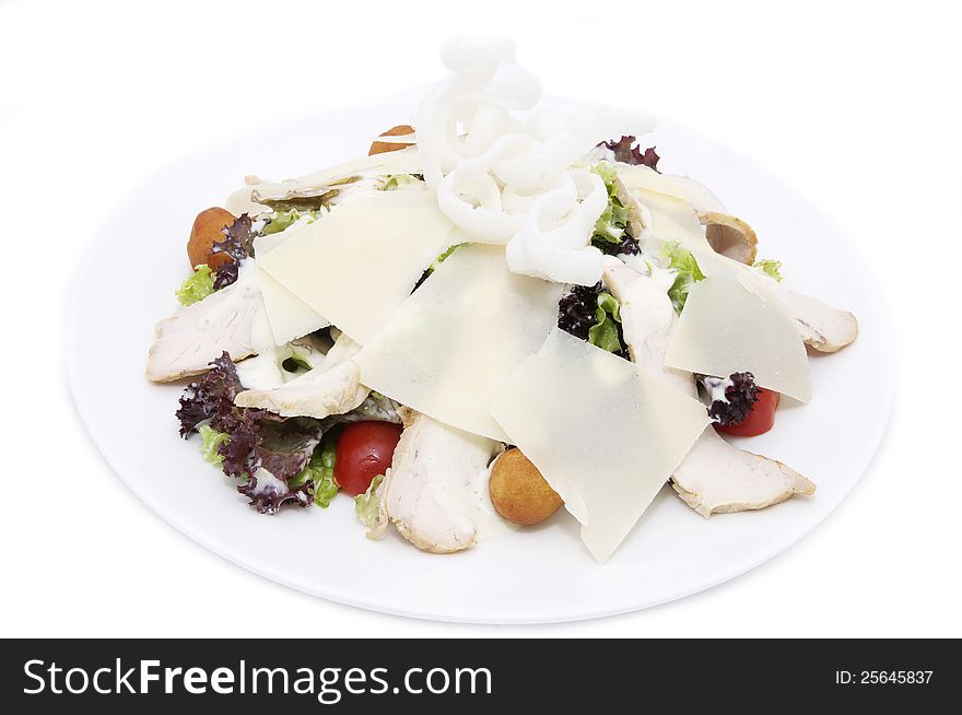 Salad with vegetables, meat and cheese on white background