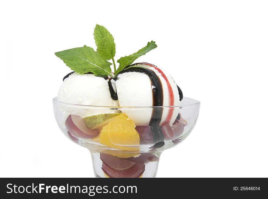 Balls of ice cream decorated with mint on a white background in the restaurant