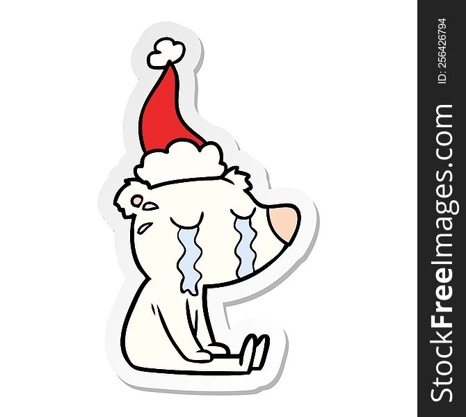 hand drawn sticker cartoon of a crying sitting polar bear wearing santa hat