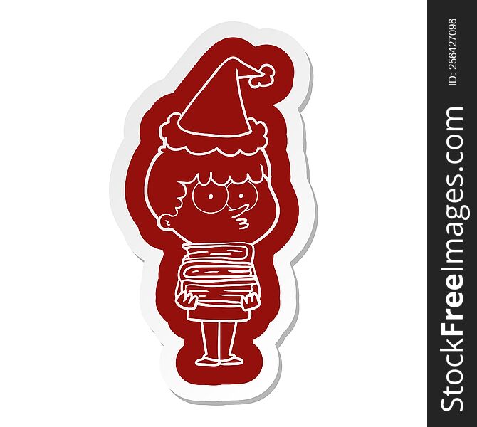 cartoon  sticker of a curious boy with lots of books wearing santa hat