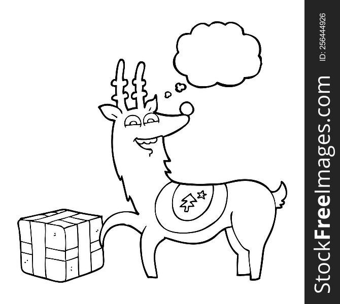 freehand drawn thought bubble cartoon christmas reindeer with present