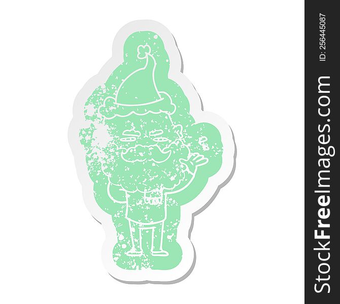 quirky cartoon distressed sticker of a dismissive man with beard frowning wearing santa hat