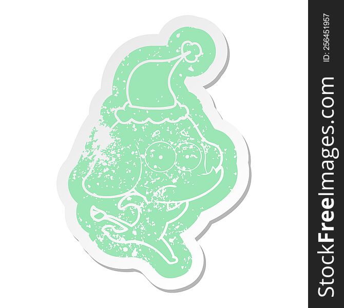 quirky cartoon distressed sticker of a unsure elephant running away wearing santa hat