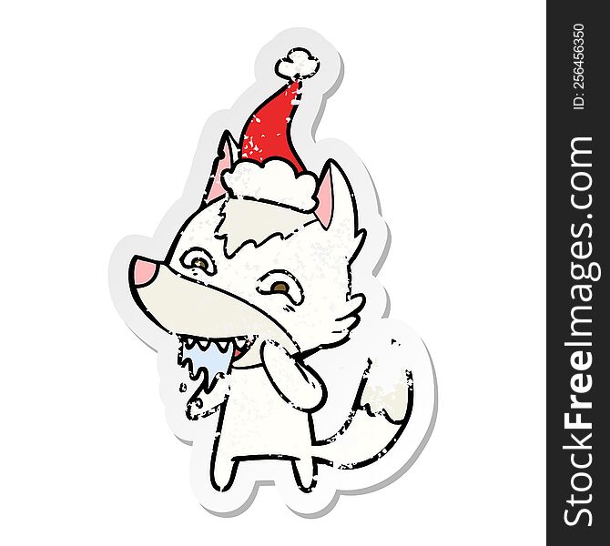 distressed sticker cartoon of a hungry wolf wearing santa hat