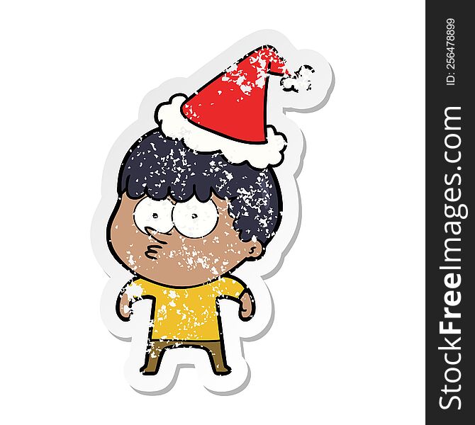 distressed sticker cartoon of a curious boy wearing santa hat