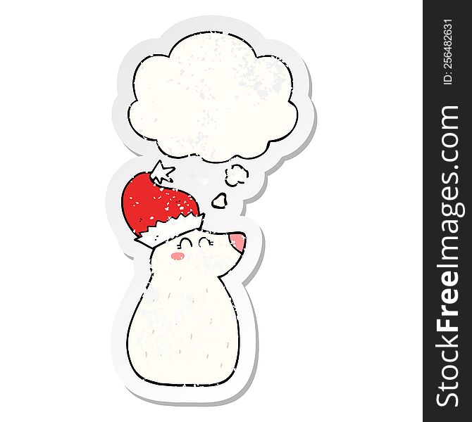 cartoon bear wearing christmas hat with thought bubble as a distressed worn sticker