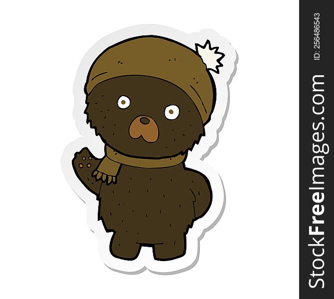 Sticker Of A Cartoon Cute Black Bear In Winter Hat And Scarf