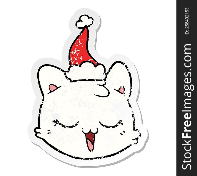 Distressed Sticker Cartoon Of A Cat Face Wearing Santa Hat