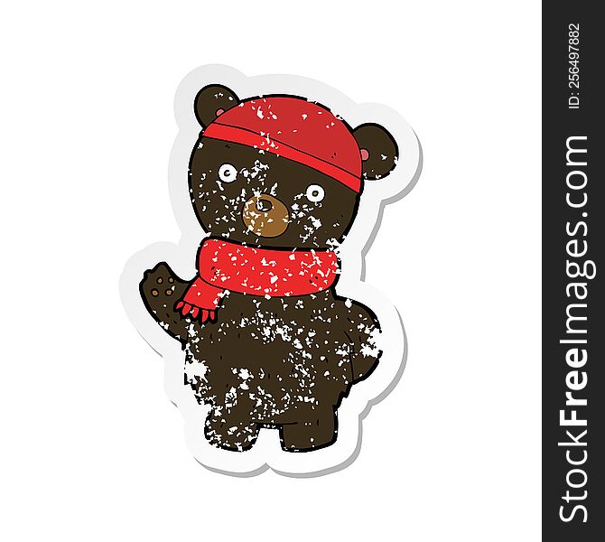 retro distressed sticker of a cartoon black bear in winter hat and scarf