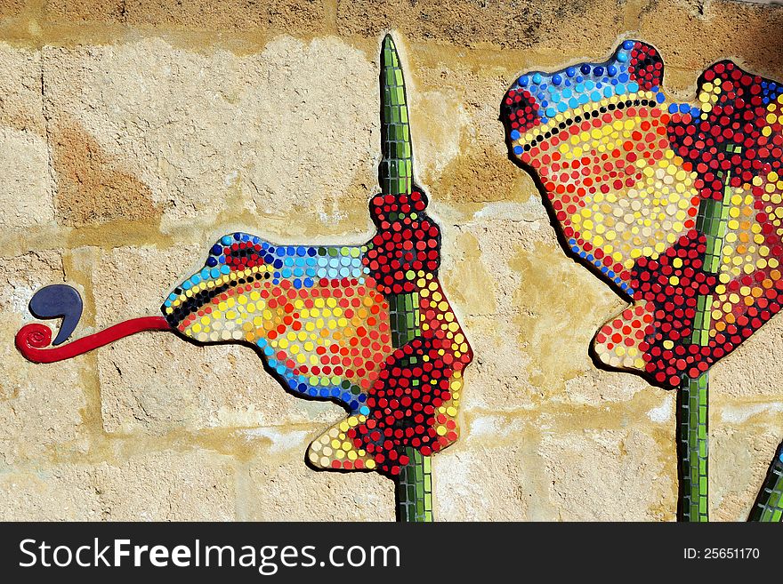 The playful frogs have been painted with dobs of bright colour on a concrete wall in a children's playground and are delightful. The playful frogs have been painted with dobs of bright colour on a concrete wall in a children's playground and are delightful.