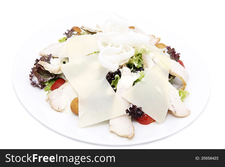 Caesar salad on a white plate in a restaurant