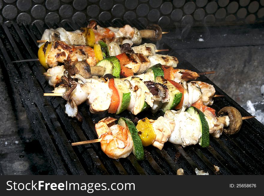 Cooking skewers of seafood in a restaurant