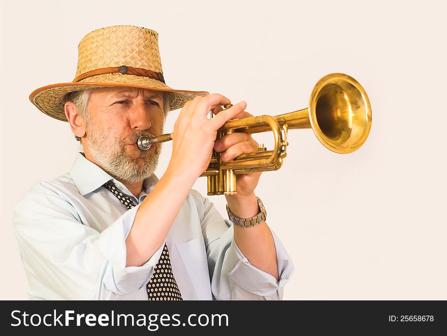 Horizontal image showing a matured, graying, unshaved trumpeter over 50 wearing a straw hut. His face is wrinkled, but happy, his eyes closed. He plays a brass trumpet. An effort visible on his face. Horizontal image showing a matured, graying, unshaved trumpeter over 50 wearing a straw hut. His face is wrinkled, but happy, his eyes closed. He plays a brass trumpet. An effort visible on his face.