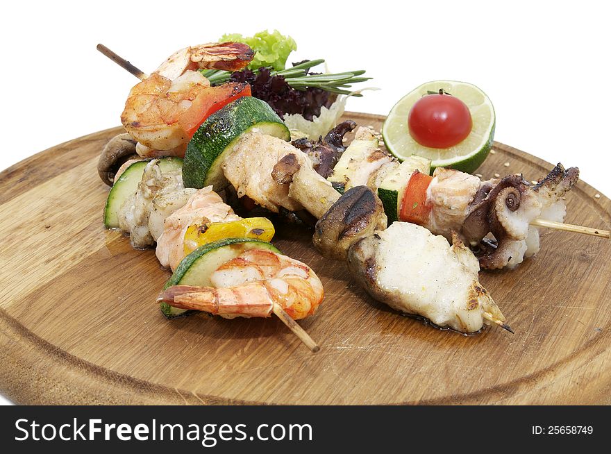 Skewers of seafood on a wooden platter in a restaurant