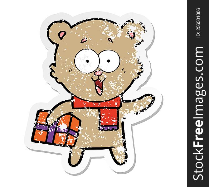 distressed sticker of a laughing teddy  bear with christmas present