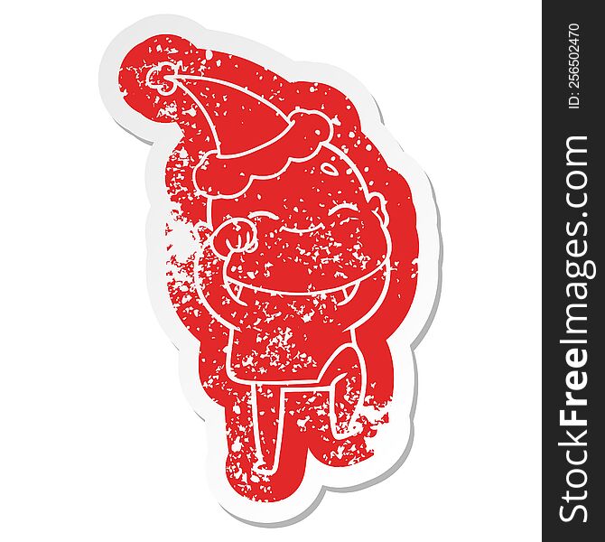 happy quirky cartoon distressed sticker of a bald man wearing santa hat