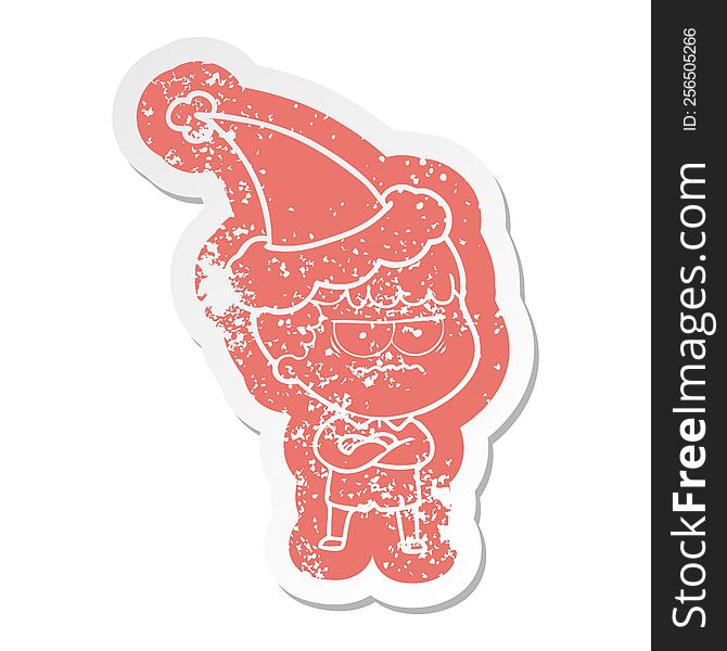 Cartoon Distressed Sticker Of An Annoyed Man Wearing Santa Hat
