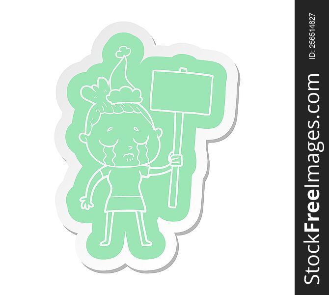 quirky cartoon  sticker of a crying woman with protest sign wearing santa hat