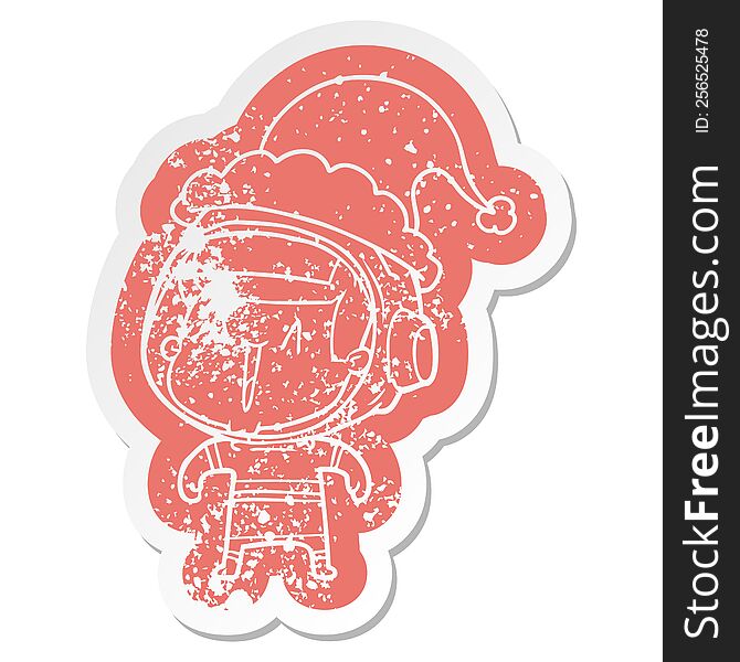 quirky cartoon distressed sticker of a astronaut man wearing santa hat