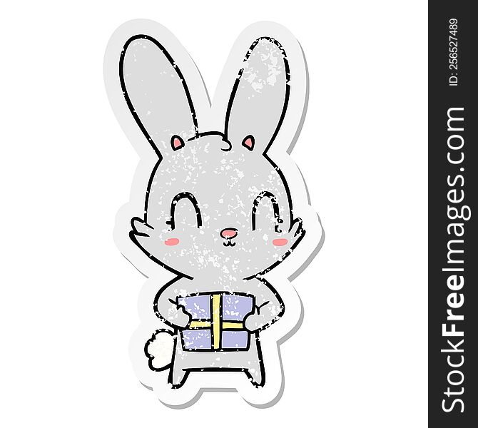 Distressed Sticker Of A Cute Cartoon Rabbit With Present