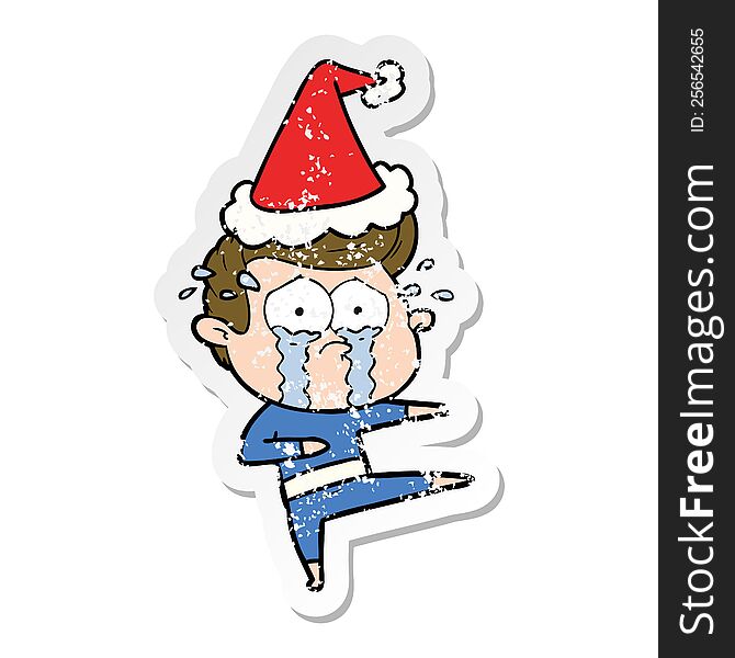 Distressed Sticker Cartoon Of A Crying Dancer Wearing Santa Hat