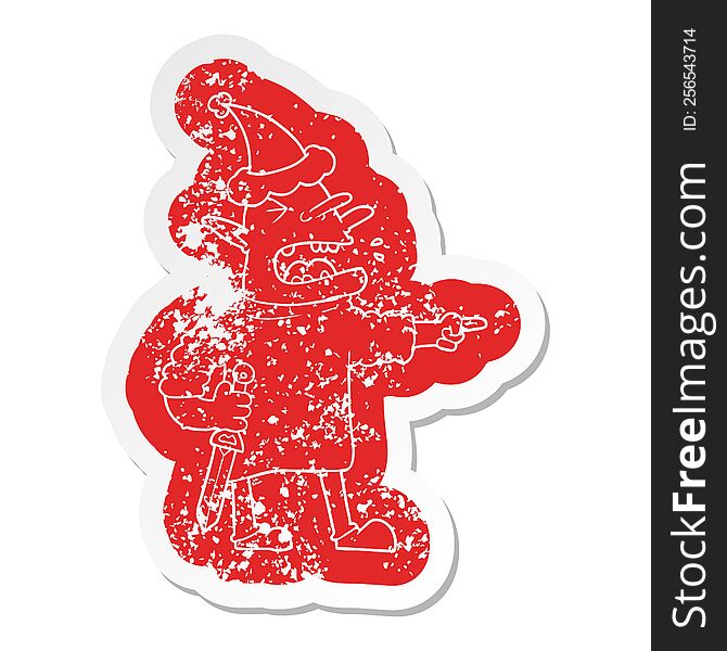 Cartoon Distressed Sticker Of A Goblin With Knife Wearing Santa Hat