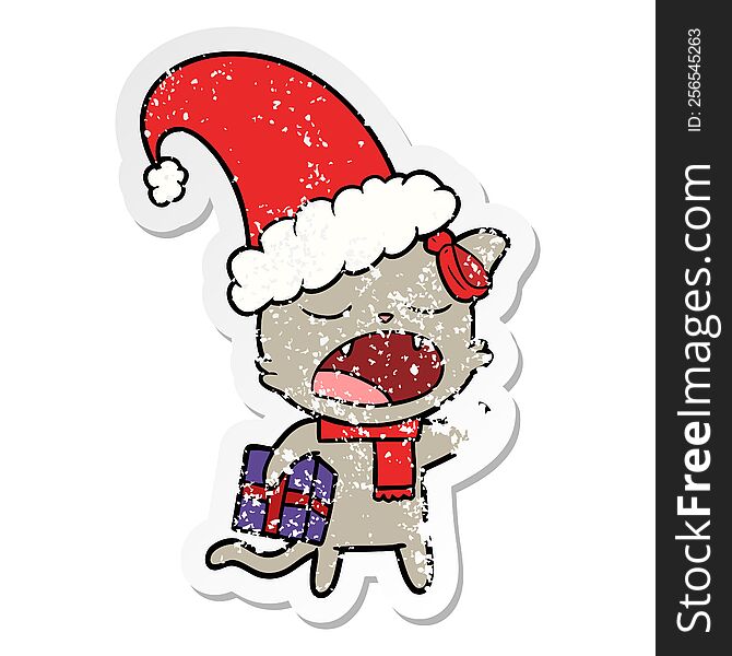 distressed sticker of a cartoon cat with christmas present