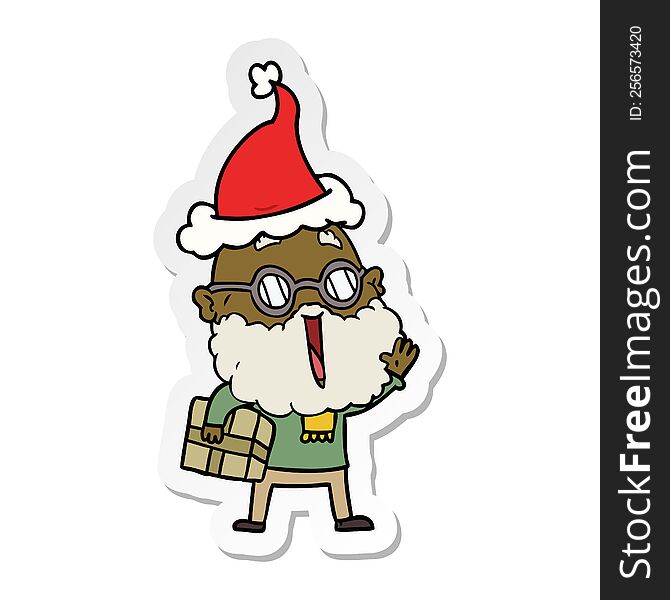 hand drawn sticker cartoon of a joyful man with beard and parcel under arm wearing santa hat