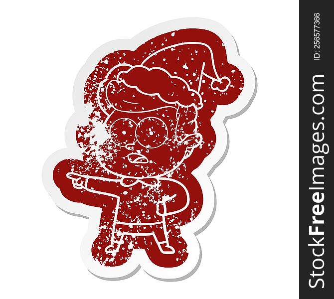 Cartoon Distressed Sticker Of A Staring Man Wearing Santa Hat