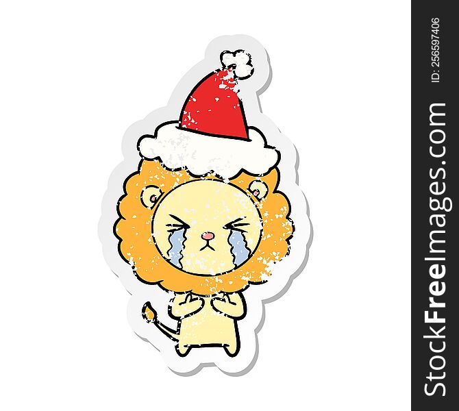Distressed Sticker Cartoon Of A Crying Lion Wearing Santa Hat