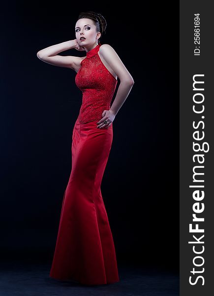 Graceful woman in modern long dress posing