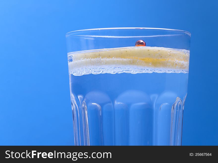 Cocktail with apple and candy  on blue background
