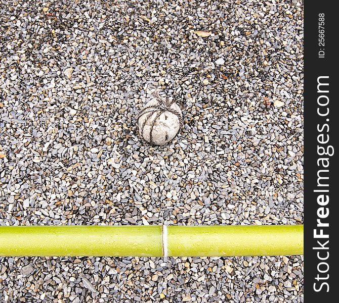 Zen garden fragment with green bamboo pole. Zen garden fragment with green bamboo pole