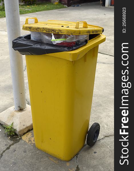 Close up of yellow full trash can