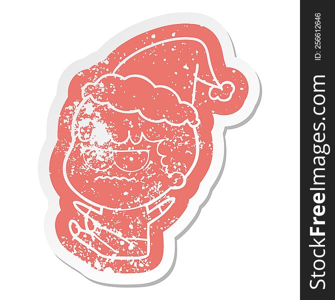 Cartoon Distressed Sticker Of A Annoyed Man Wearing Santa Hat